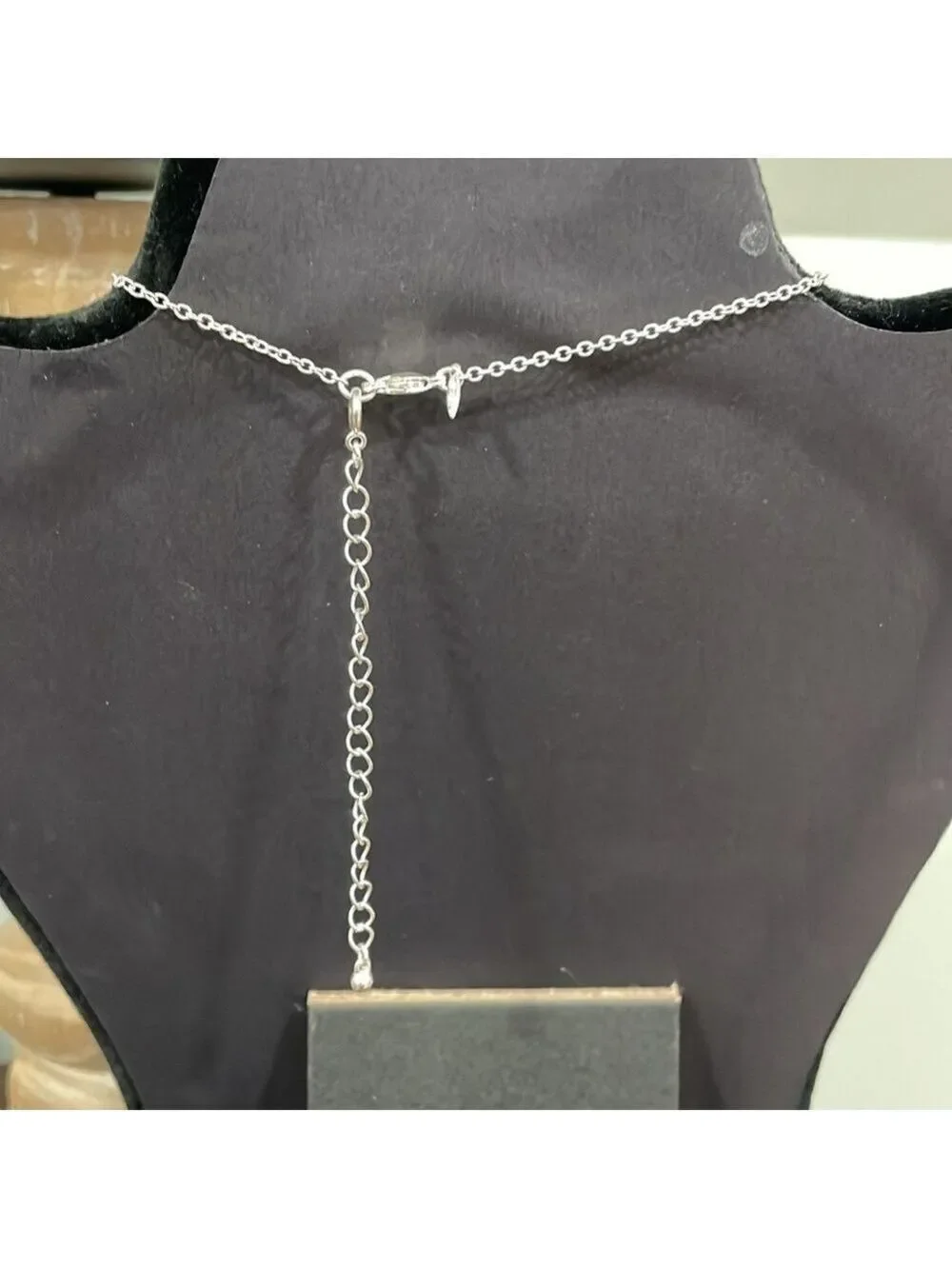Avon White triple stone pendant with silver tone chain and removable extender